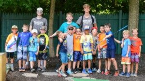 Two Summer Trails staff members along with a group of campers.