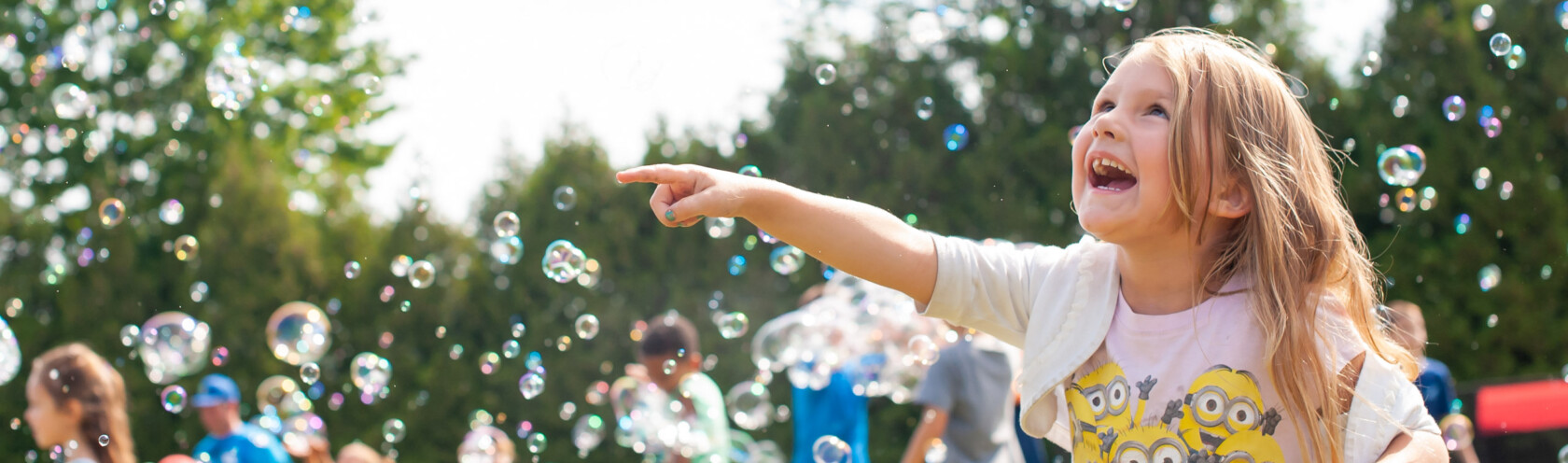 Campers playing with bubbles outside.