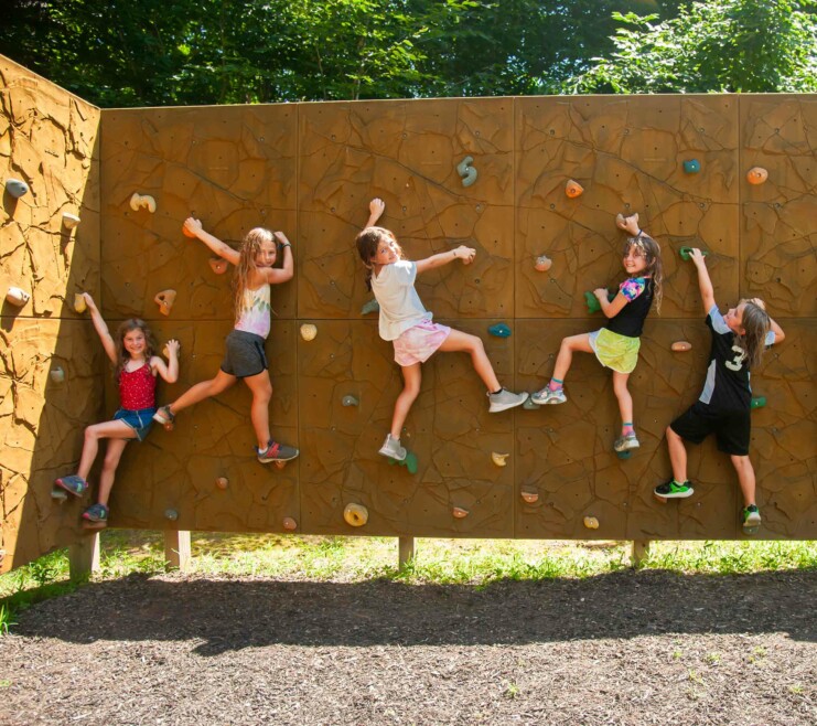Campers on a rock climbing wall.