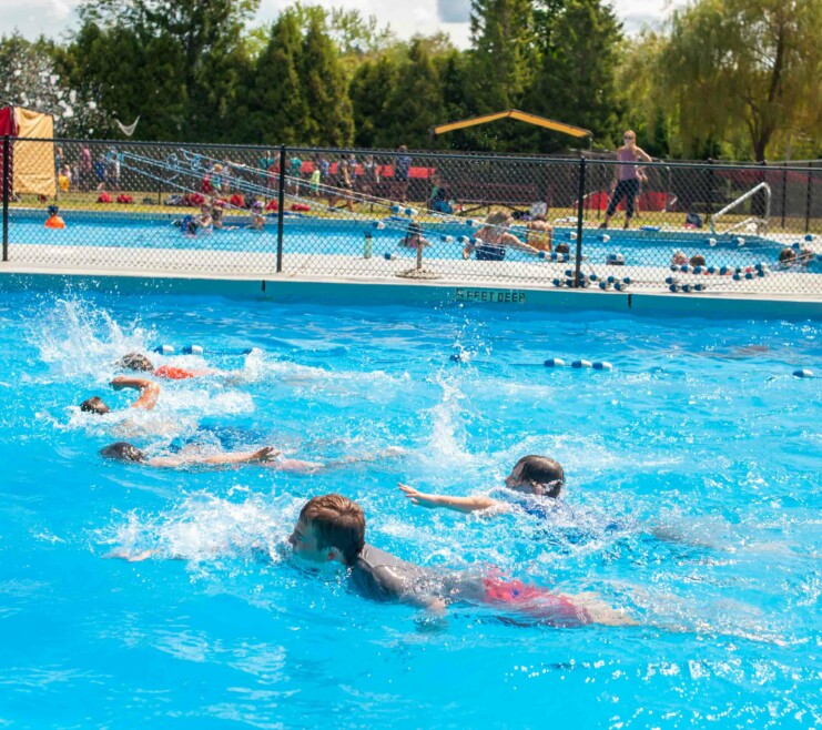 Campers swimming in a pool.