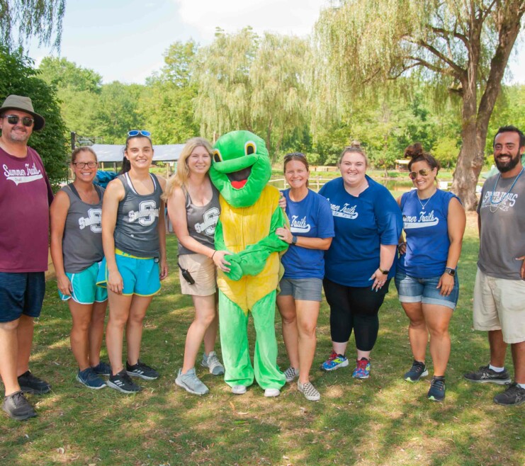 Summer Trails staff with a mascot.